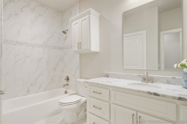 full bathroom featuring tiled shower / bath combo, large vanity, and toilet