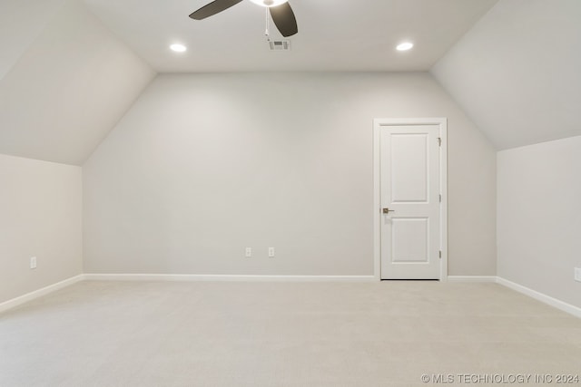 additional living space with ceiling fan, vaulted ceiling, and light colored carpet