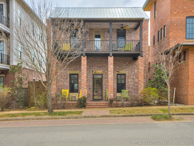 view of front of house with a balcony and ceiling fan