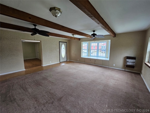 unfurnished living room featuring carpet floors, heating unit, ceiling fan, and beamed ceiling