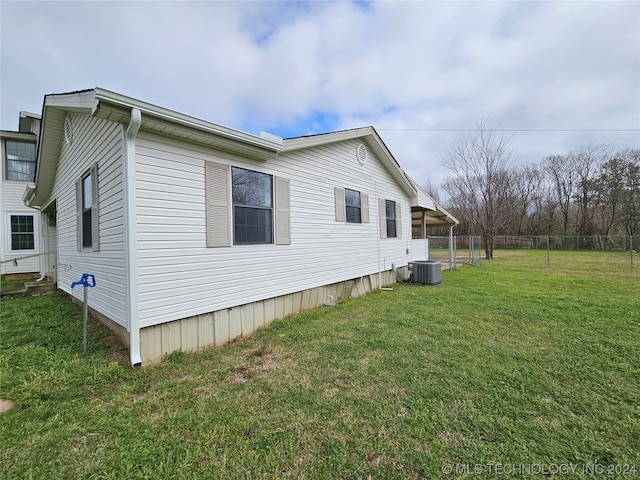 view of property exterior featuring a yard and central AC unit