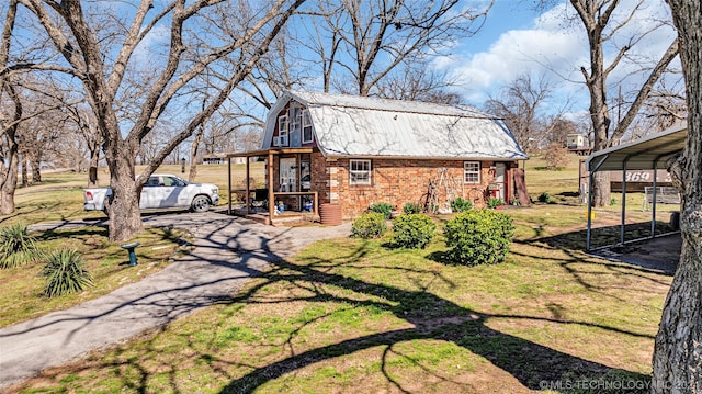 exterior space with a carport, a lawn, and covered porch