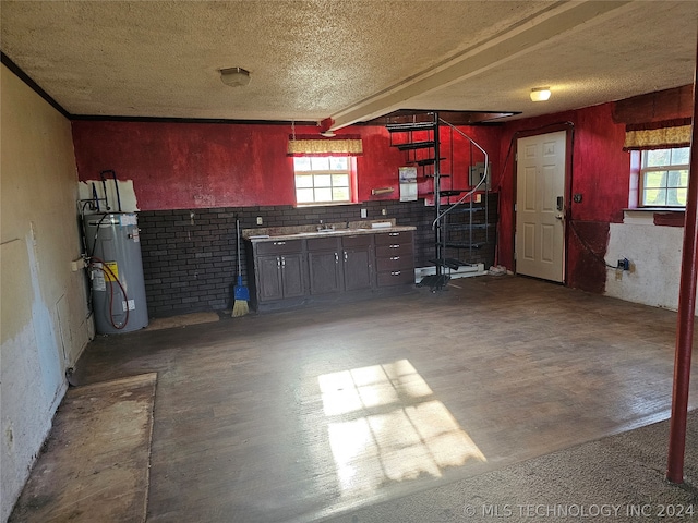 interior space with sink, fridge, and a textured ceiling