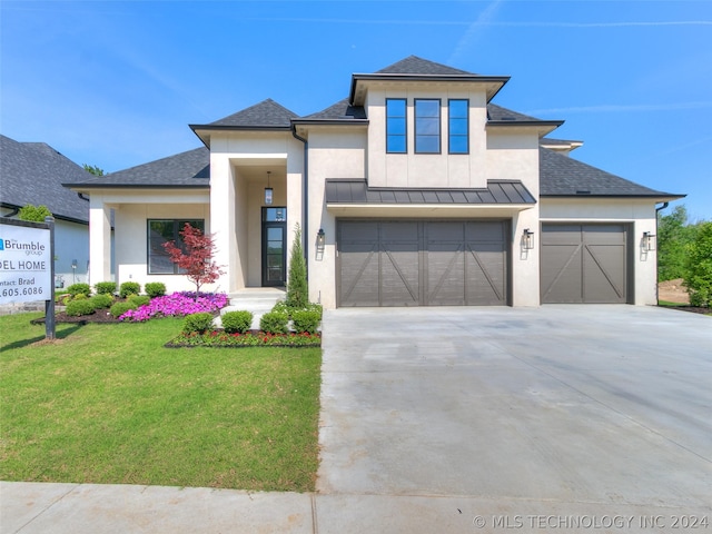 view of front of home with a garage and a front yard