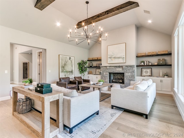 living room featuring beamed ceiling, a fireplace, light wood-type flooring, a notable chandelier, and high vaulted ceiling