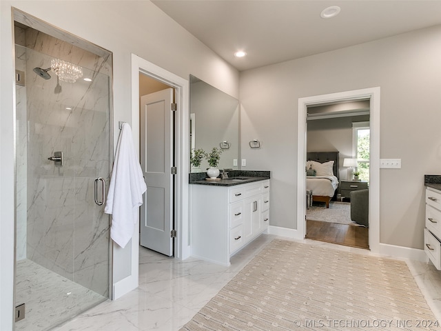 bathroom featuring tile flooring, tiled shower, and vanity