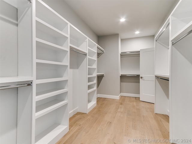 walk in closet with light wood-type flooring