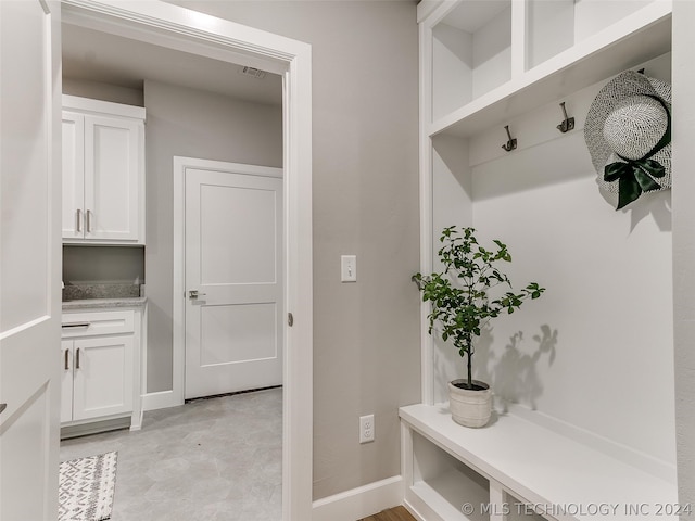 mudroom featuring light tile floors