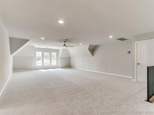 bonus room with lofted ceiling, ceiling fan, and light colored carpet