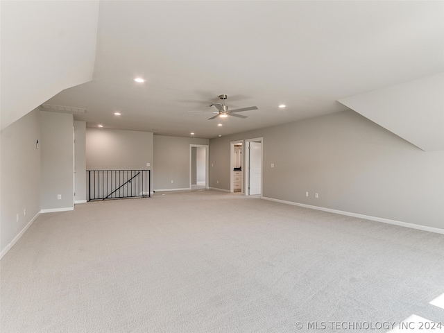 additional living space featuring carpet and ceiling fan