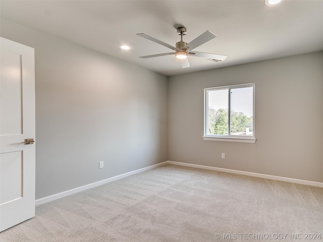 carpeted empty room featuring ceiling fan