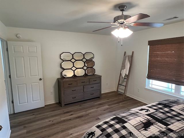 unfurnished bedroom with ceiling fan and dark hardwood / wood-style floors