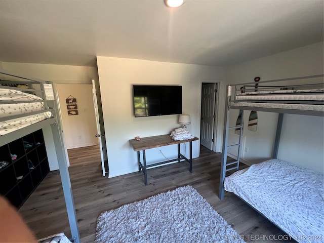 bedroom with dark wood-type flooring