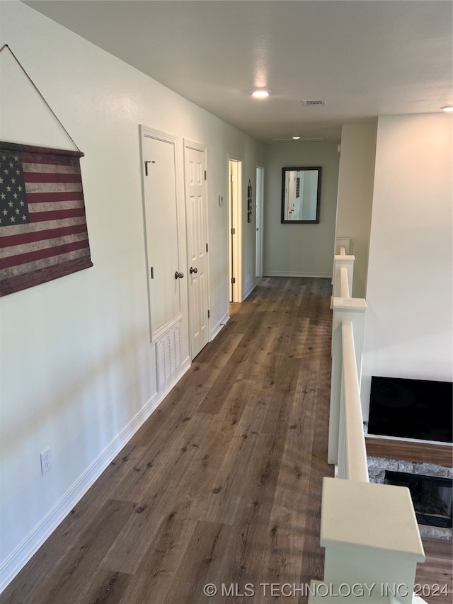 hall with dark hardwood / wood-style flooring