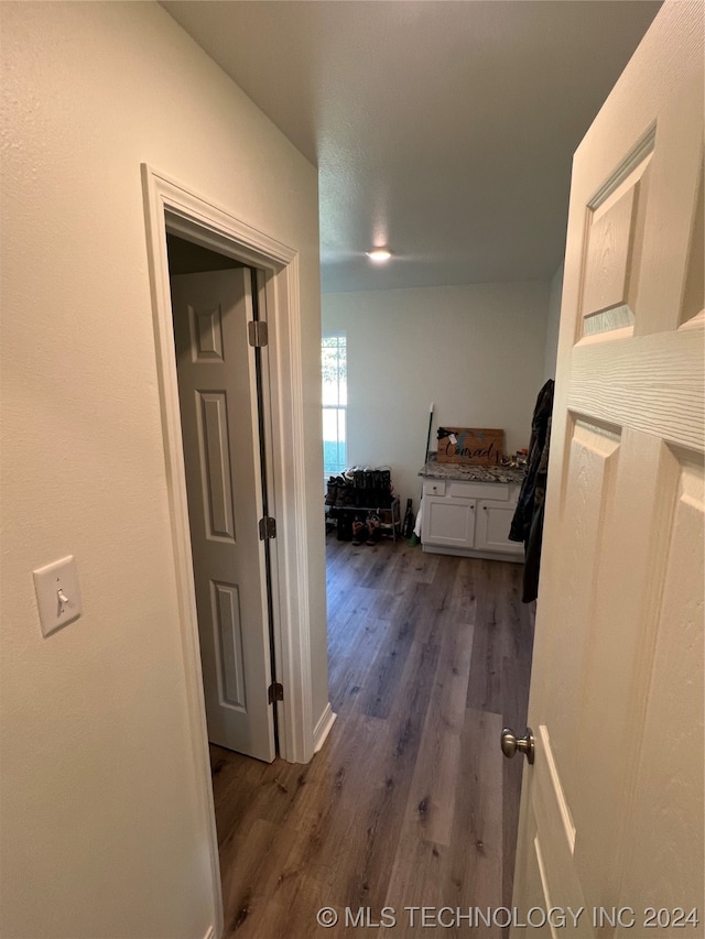 hallway with hardwood / wood-style flooring