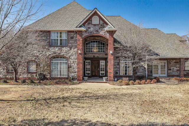 view of front of property with a front lawn and french doors