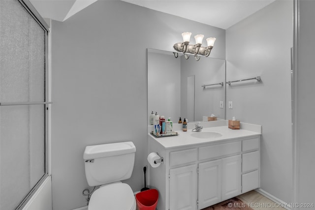 bathroom featuring toilet, vanity, and a chandelier