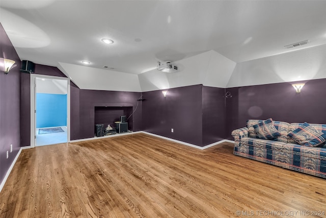 interior space with light hardwood / wood-style floors and vaulted ceiling