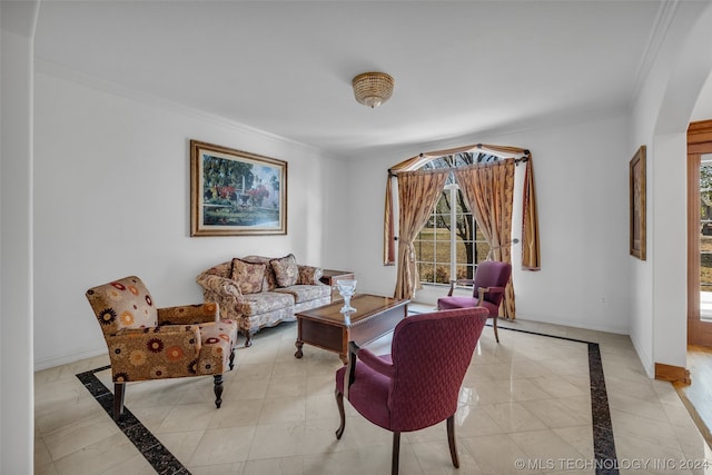 living room featuring crown molding, light tile floors, and a healthy amount of sunlight