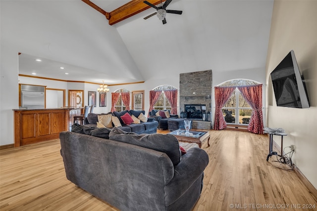 living room with beamed ceiling, a stone fireplace, light hardwood / wood-style flooring, high vaulted ceiling, and ceiling fan with notable chandelier