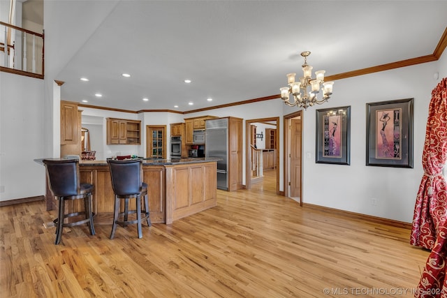 kitchen featuring pendant lighting, a kitchen breakfast bar, stainless steel appliances, light wood-type flooring, and an inviting chandelier