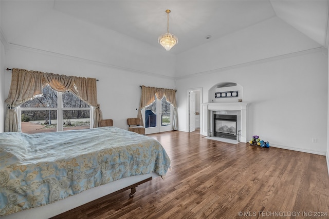 bedroom with high vaulted ceiling and dark wood-type flooring