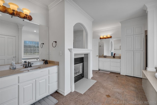 bathroom featuring tile flooring, ornamental molding, and vanity