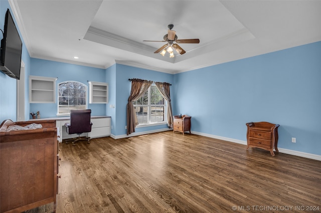 unfurnished bedroom featuring ceiling fan, a tray ceiling, and wood-type flooring