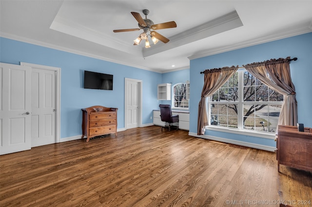 interior space with ceiling fan, a raised ceiling, hardwood / wood-style flooring, and ornamental molding