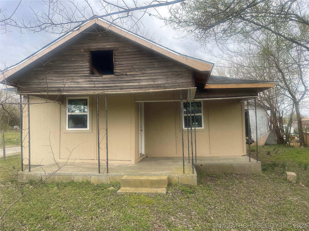 rear view of house with a yard