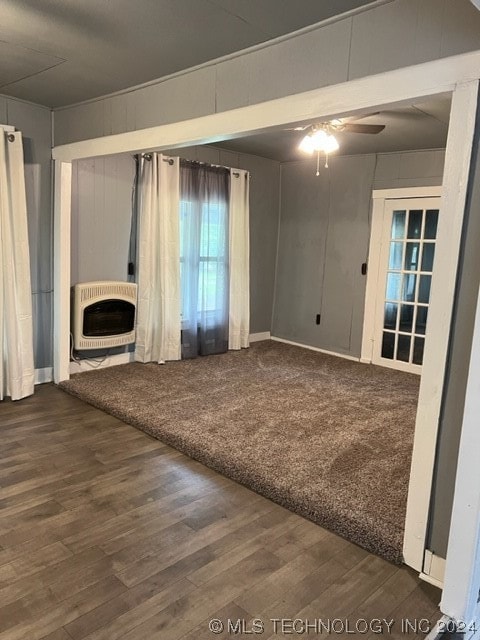 unfurnished living room featuring ceiling fan and wood-type flooring