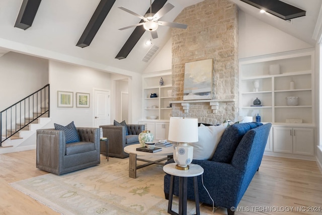 living room with built in features, light hardwood / wood-style flooring, ceiling fan, and high vaulted ceiling