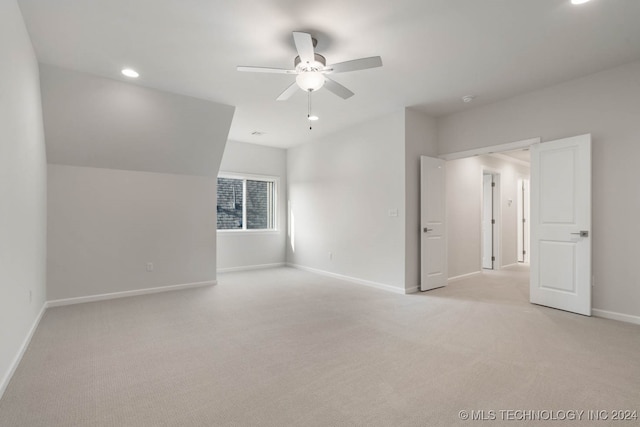 interior space featuring light colored carpet and ceiling fan