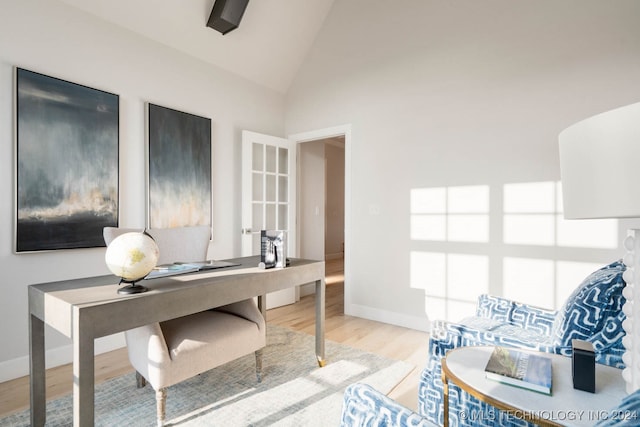 office area featuring high vaulted ceiling and light hardwood / wood-style floors