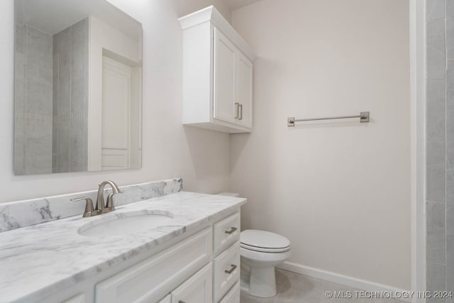 bathroom featuring tile patterned floors, toilet, and vanity