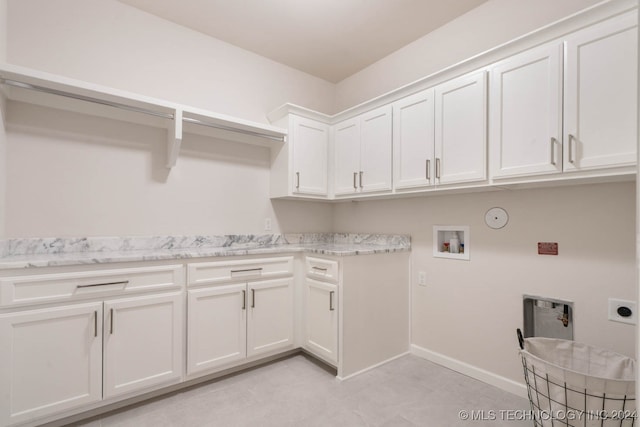 laundry room featuring hookup for a washing machine, cabinets, gas dryer hookup, and electric dryer hookup