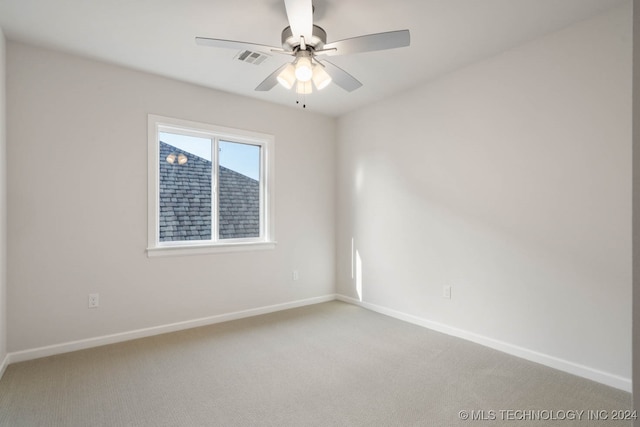 carpeted spare room with ceiling fan