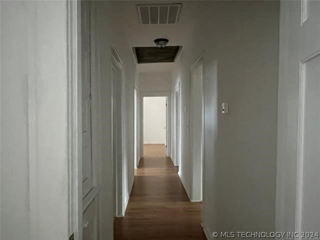 hall with dark hardwood / wood-style floors