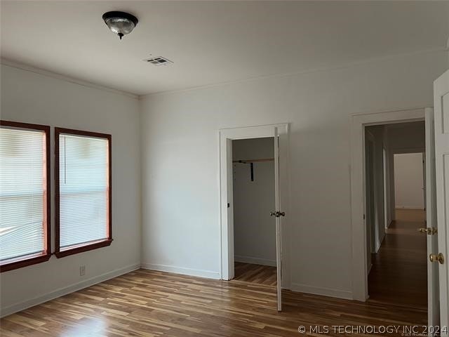 unfurnished room with hardwood / wood-style floors