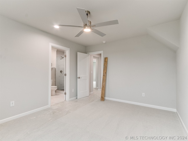 unfurnished bedroom with light carpet, connected bathroom, and ceiling fan