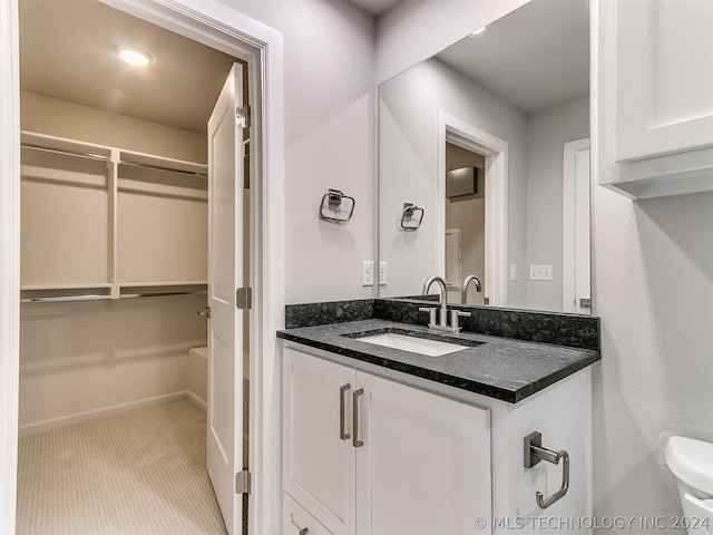 bathroom with oversized vanity and toilet