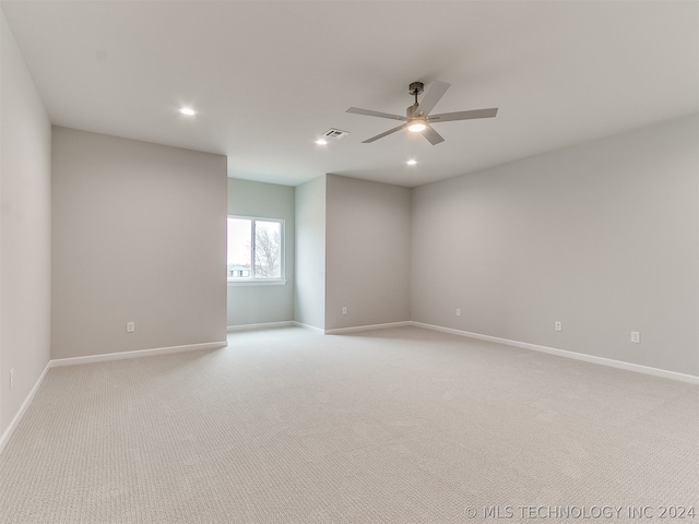 unfurnished room with ceiling fan and light carpet