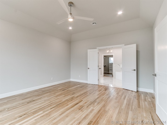 unfurnished room with vaulted ceiling, light hardwood / wood-style flooring, and ceiling fan