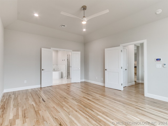 empty room with vaulted ceiling, ceiling fan, and light hardwood / wood-style flooring