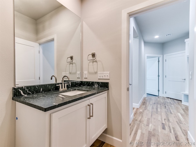 bathroom with hardwood / wood-style flooring and vanity