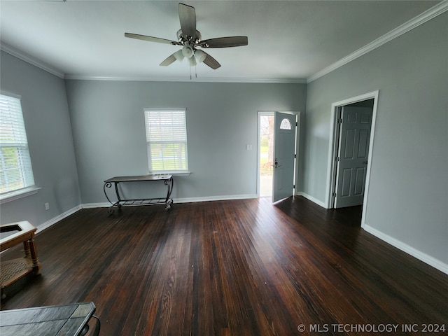 spare room with plenty of natural light, ceiling fan, and dark wood-type flooring