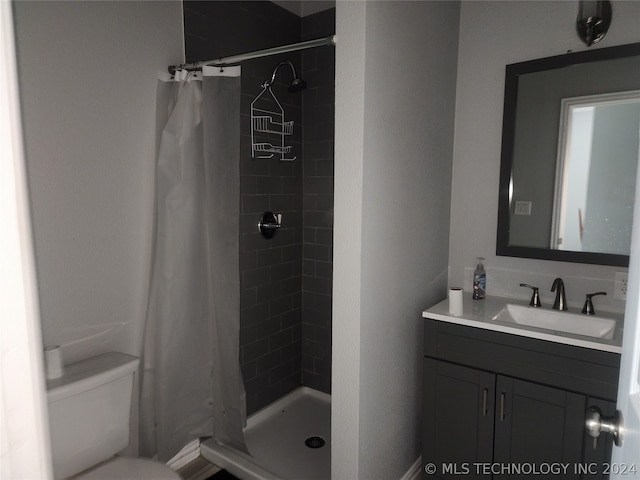 bathroom featuring a shower with curtain, toilet, and vanity