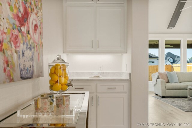 interior space with light hardwood / wood-style floors and white cabinetry