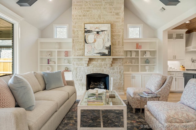 living room featuring high vaulted ceiling and a wealth of natural light