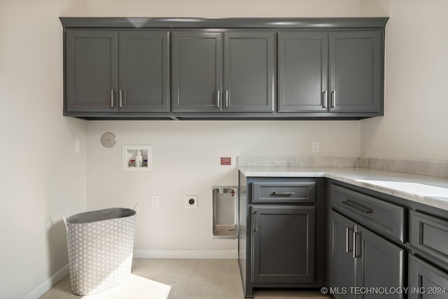 laundry room with hookup for a washing machine, cabinets, hookup for an electric dryer, and hookup for a gas dryer